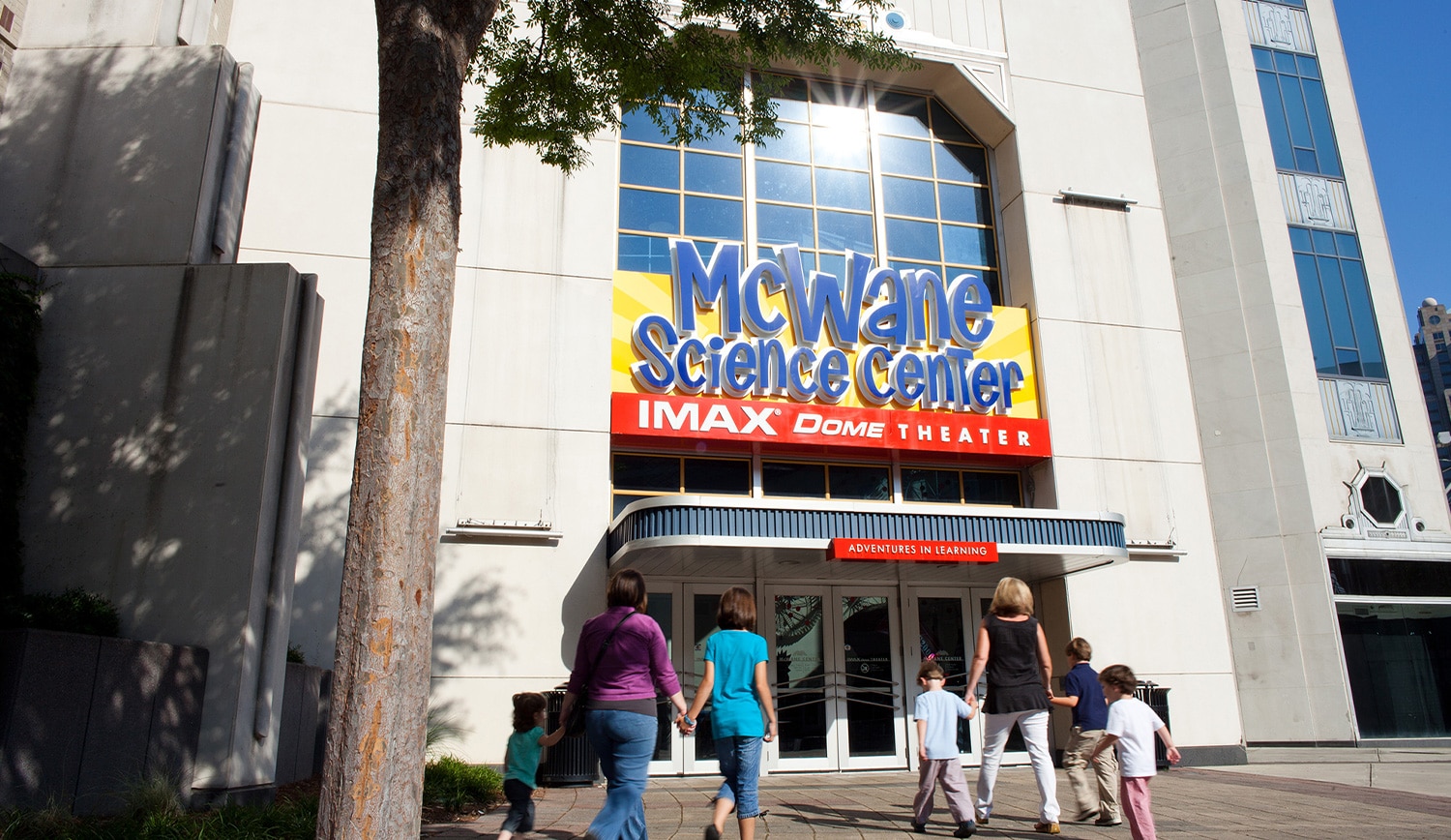 a group of people walking in front of a building