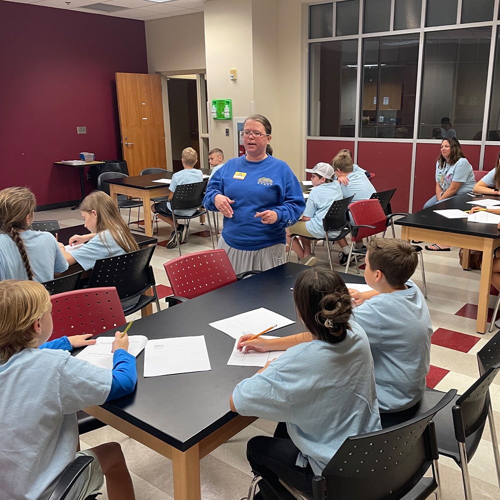 a group of people sitting at a table in a room