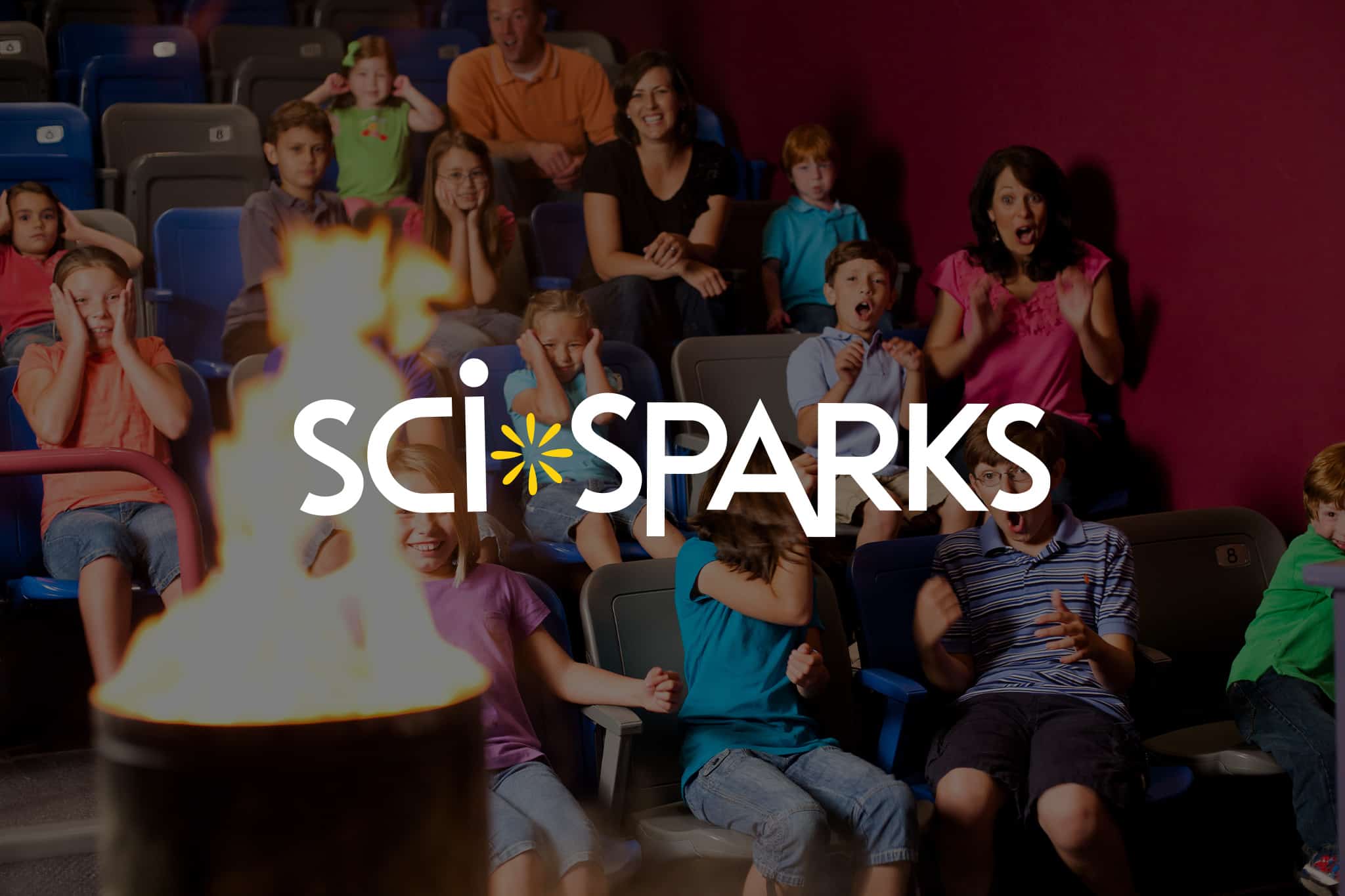 a group of people sitting in front of a crowd