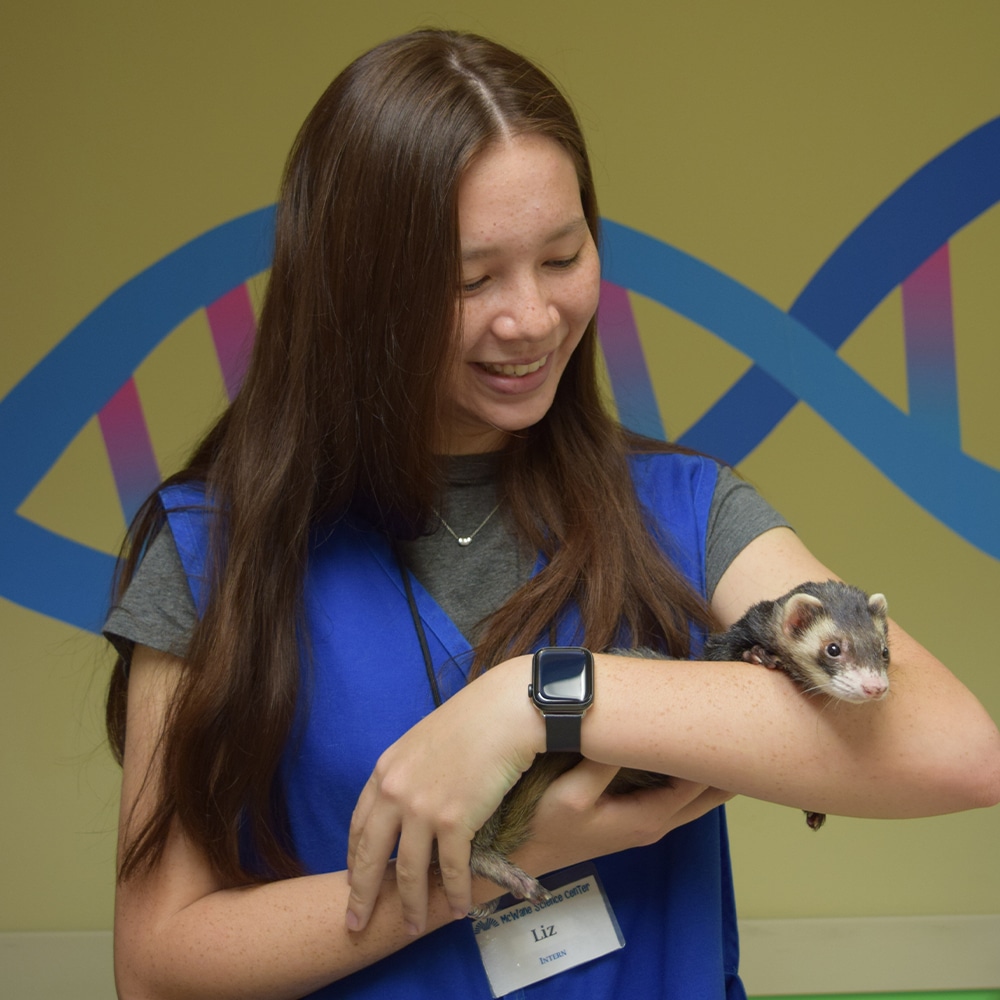 a woman holding a sign posing for the camera